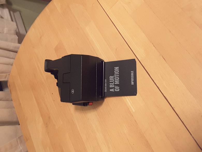 A paper sheet will dispense the first time you insert a new 8-pack of film into the camera.