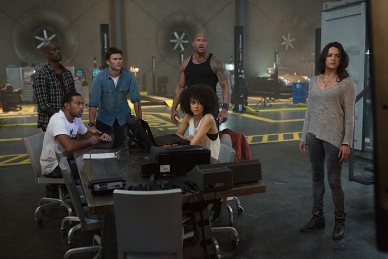 (L to R) Roman (TYRESE GIBSON), Tej (CHRIS “LUDACRIS” BRIDGES), Little Nobody (SCOTT EASTWOOD), Hobbs (DWAYNE JOHNSON), Ramsey (NATHALIE EMMANUEL) and Letty (MICHELLE RODRIGUEZ) realize Dom’s gone rogue in “The Fate of the Furious.” On the heels of 2015’s