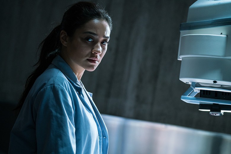 Megan (Shay Mitchell) prepares to intake the body just delivered in Screen Gems THE POSSESSION OF HANNAH GRACE. PHOTO BY: Claire Folger. ©2018 CTMG, Inc. All Rights Reserved. **ALL IMAGES ARE PROPERTY OF SONY PICTURES ENTERTAINMENT INC. FOR PROMOTIONAL US