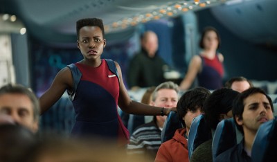 LUPITA NYONG’O as flight attendant Gwen