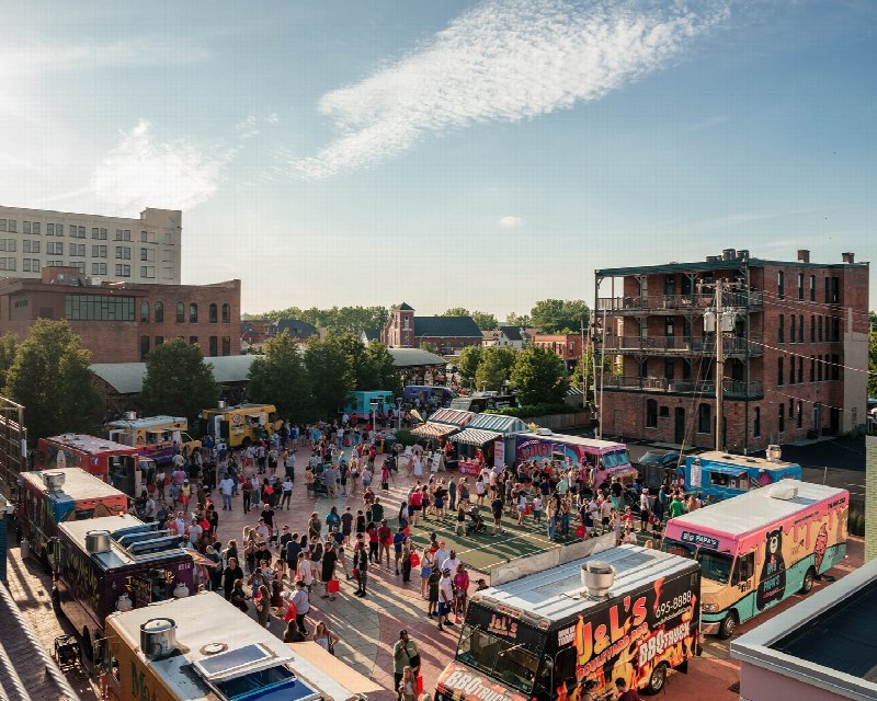 Food trucks and a crowd filling Larkin Square on a sunny Food Truck Tuesday